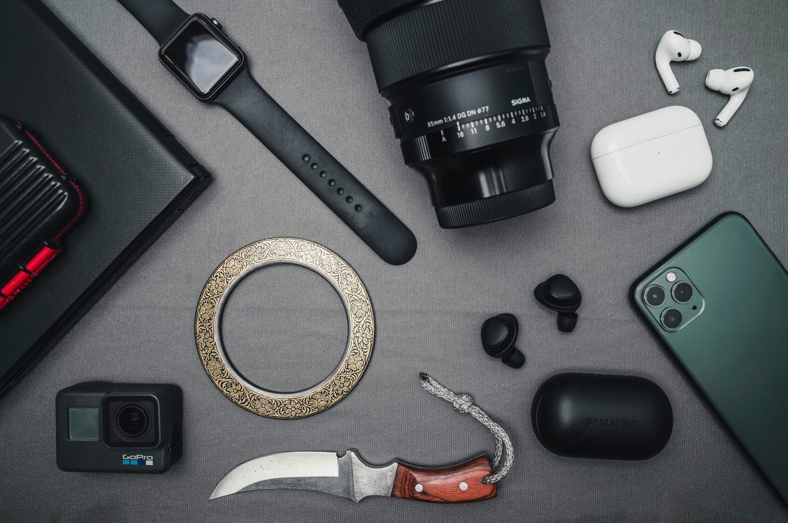 Flat lay of tech gadgets and personal accessories including camera and smartwatch available across USA