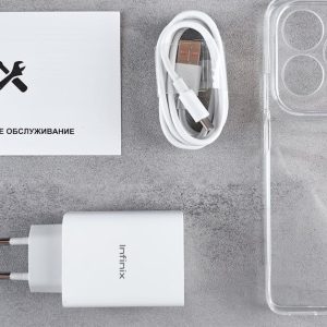 Flat lay of Infinix smartphone accessories with charger, cable, case, and warranty card.